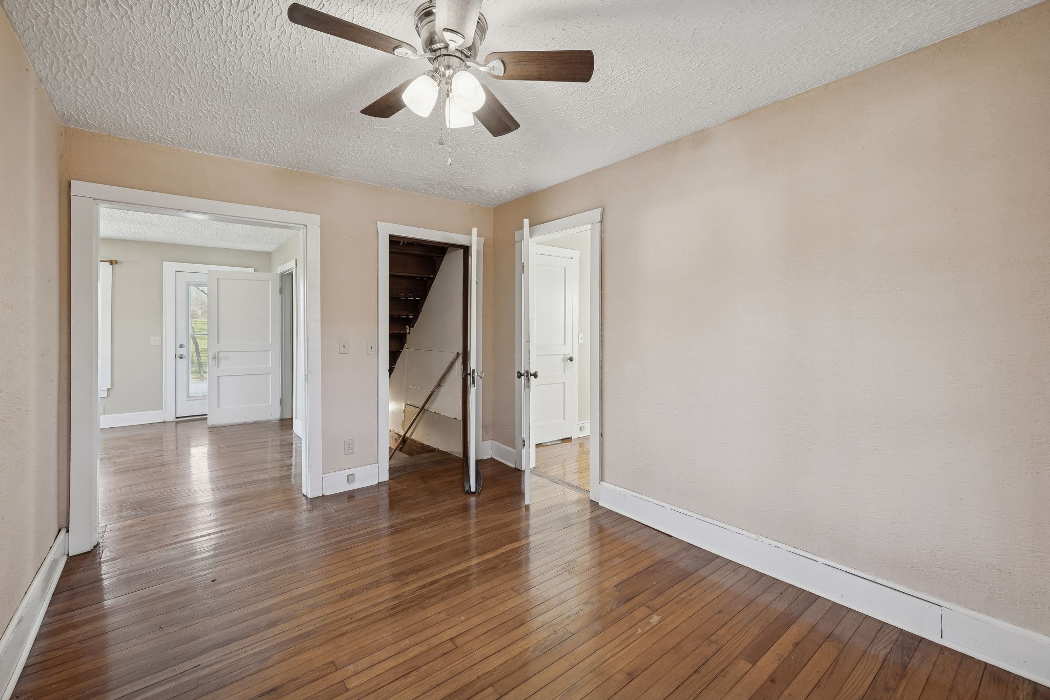 2554 Bakerton Road Red Boiling Springs, TN 37150 - Photo 20 of 46 an empty room with wooden floor chandelier fan and windows