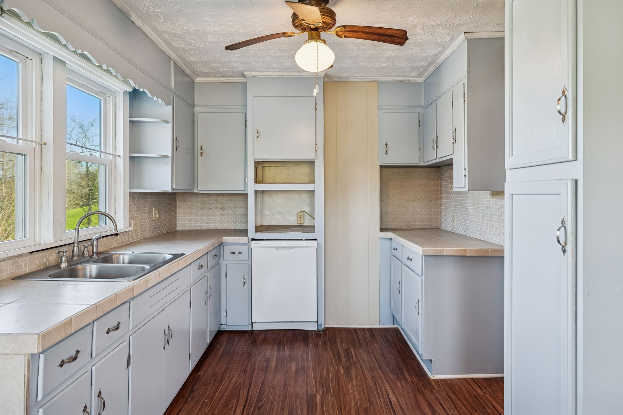 2554 Bakerton Road Red Boiling Springs, TN 37150 - Photo 23 of 46 a kitchen with a sink dishwasher and white cabinets with wooden floor