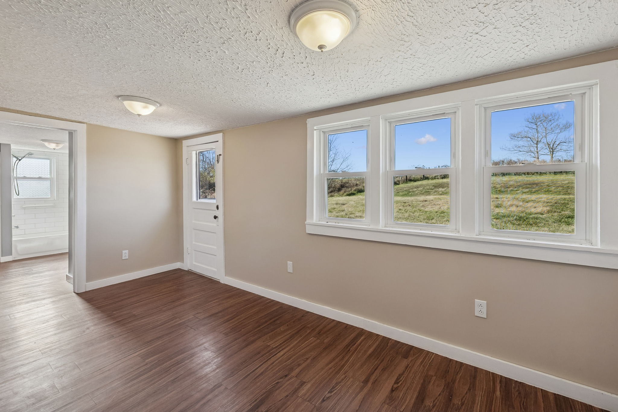 2554 Bakerton Road Red Boiling Springs, TN 37150 - Photo 25 of 46 a view of an empty room with wooden floor and a window