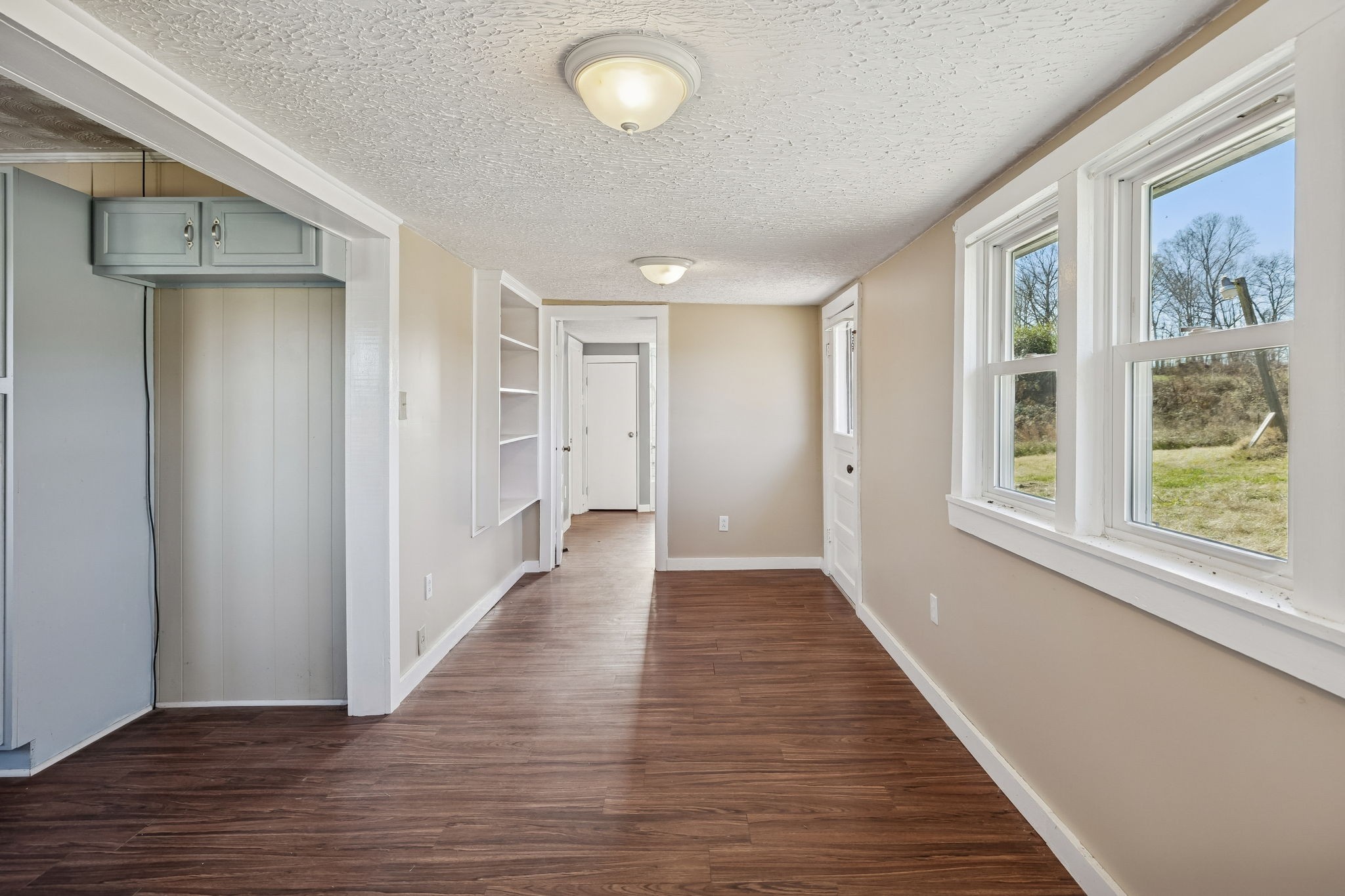 2554 Bakerton Road Red Boiling Springs, TN 37150 - Photo 26 of 46 a view of a hallway with wooden floor and windows