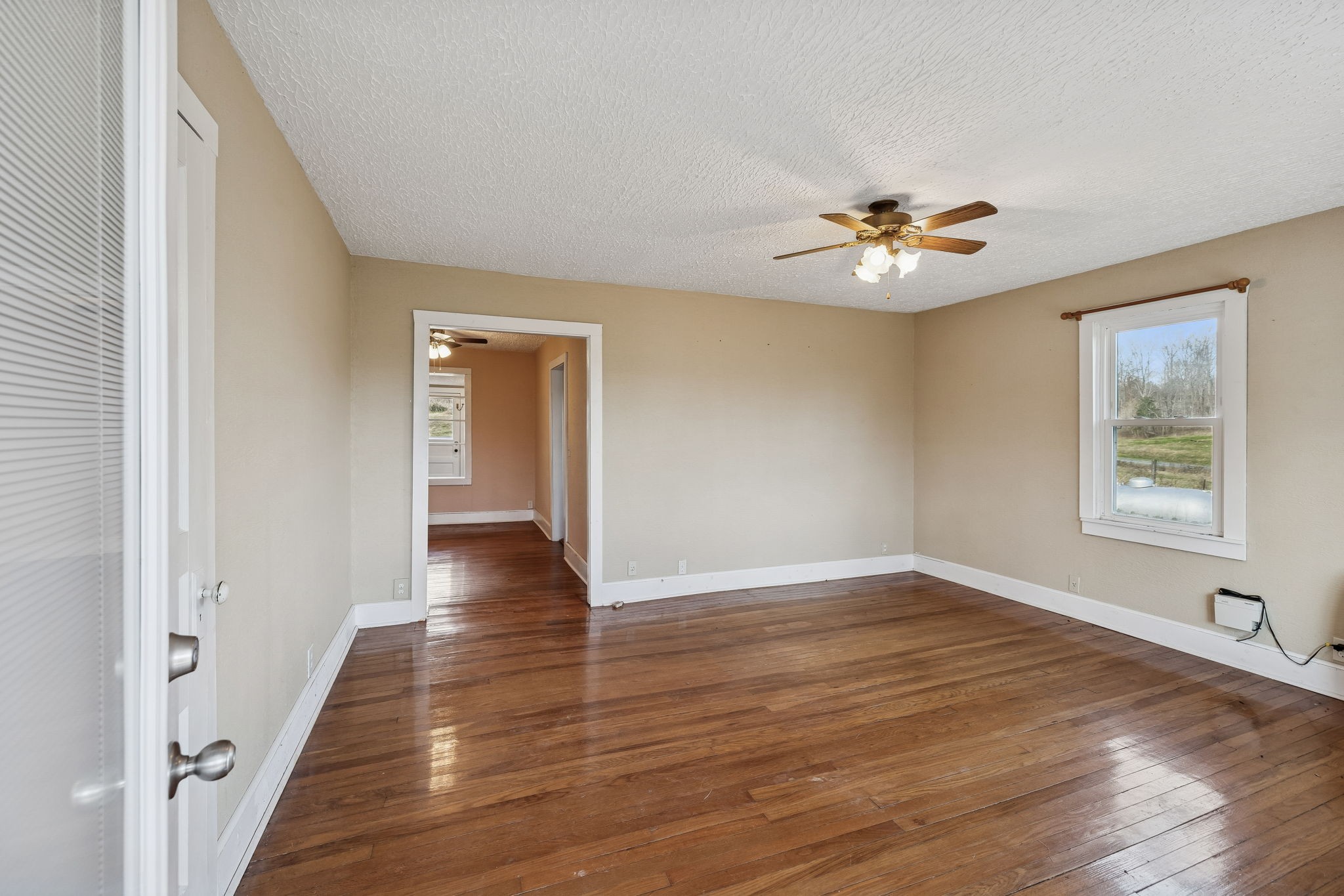 2554 Bakerton Road Red Boiling Springs, TN 37150 - Photo 7 of 46 a view of an empty room with a window and wooden floor