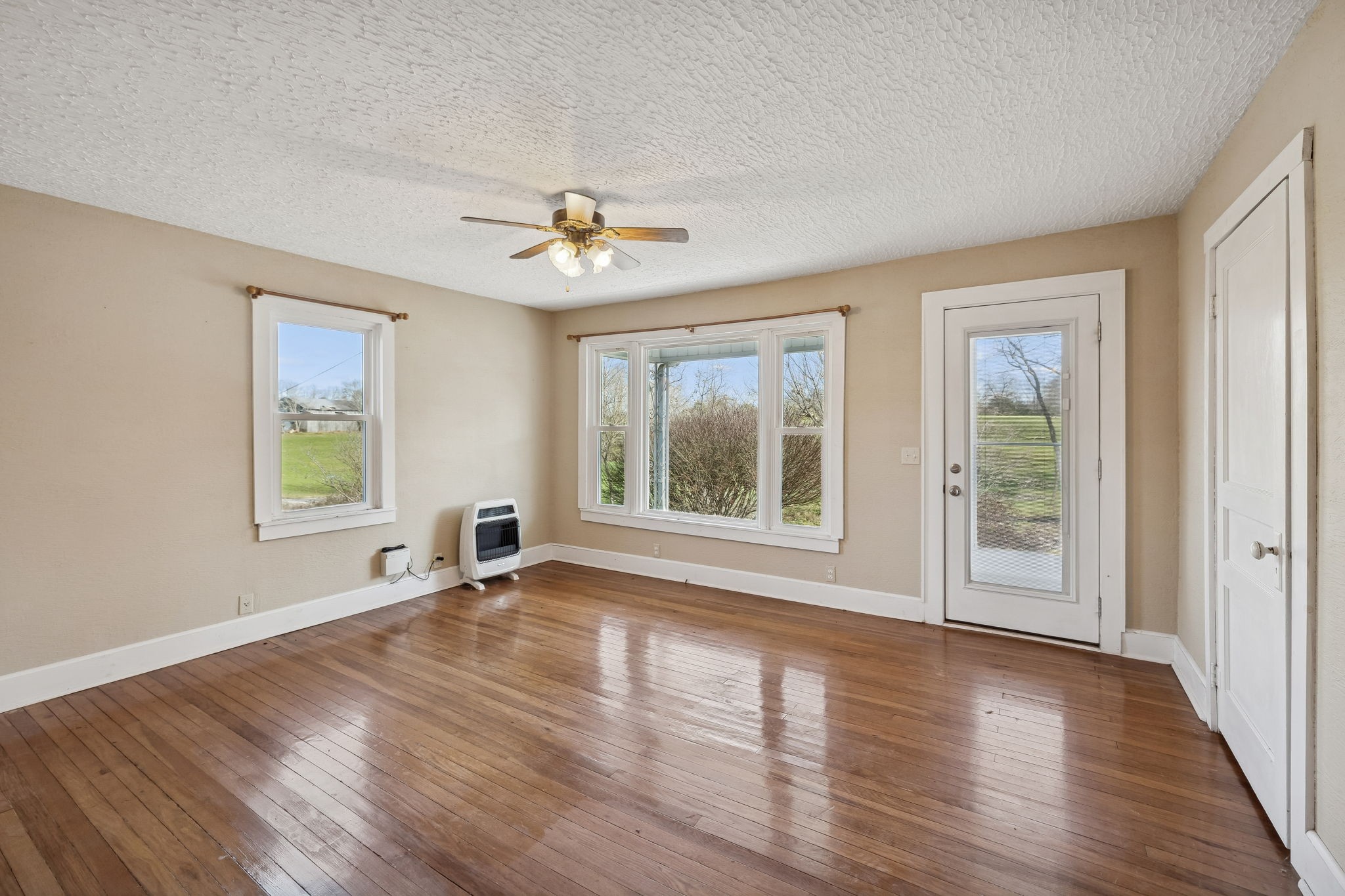 2554 Bakerton Road Red Boiling Springs, TN 37150 - Photo 9 of 46 a view of an empty room with a window and wooden floor