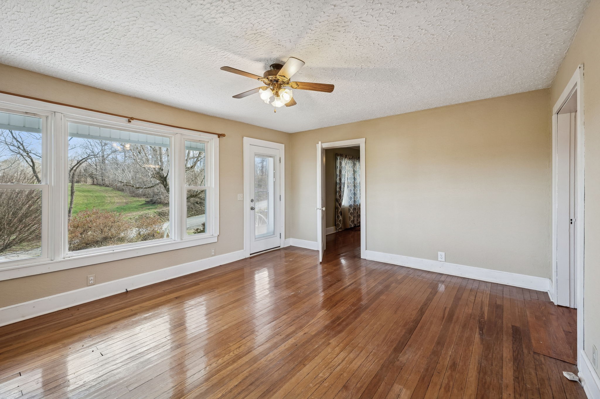 2554 Bakerton Road Red Boiling Springs, TN 37150 - Photo 10 of 46 a view of an empty room with wooden floor and a window