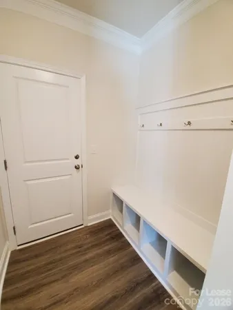 a view of storage and utility room with wooden floor