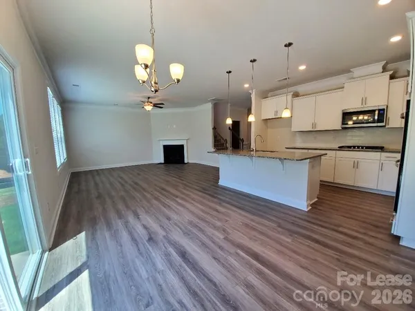 a view of a kitchen with sink and wooden floor