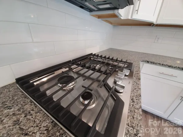 a close up of a stove top oven sitting inside of a kitchen