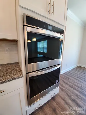 a stove top oven sitting inside of a kitchen