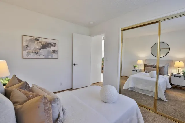 a bedroom with bed and a chandelier