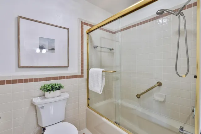 a bathroom with a shower a toilet and a sink