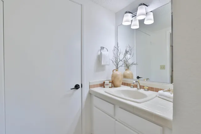 a bathroom with a sink vanity and a mirror