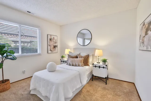 a bedroom with a bed and window