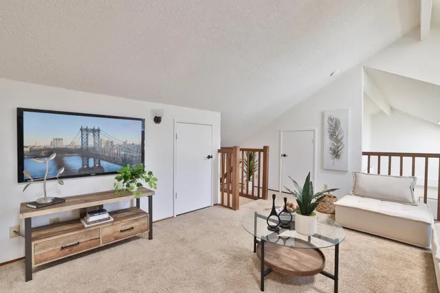 a living room with furniture and a potted plant