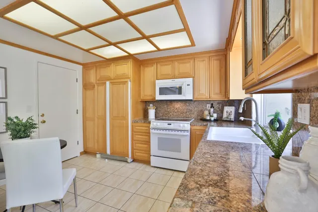 a kitchen with windows and refrigerator