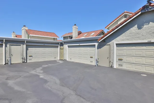 a view of house with garage and large window