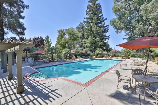 an outdoor space with pool and furniture