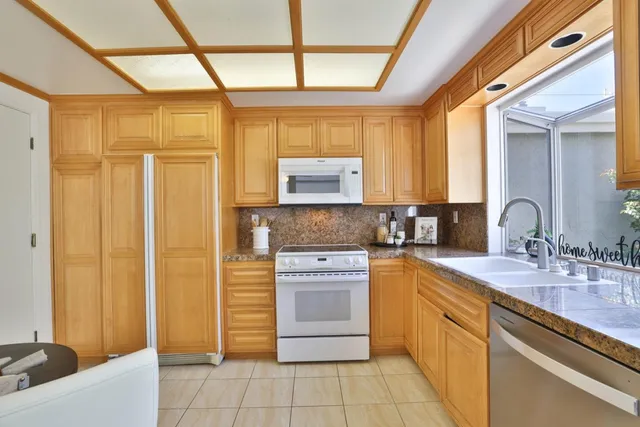 a kitchen with stainless steel appliances granite countertop a sink and cabinets