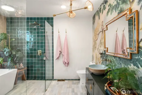 a bathroom with a granite countertop sink a toilet and shower