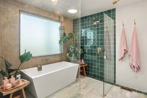 a bathroom with a bath tub and shower