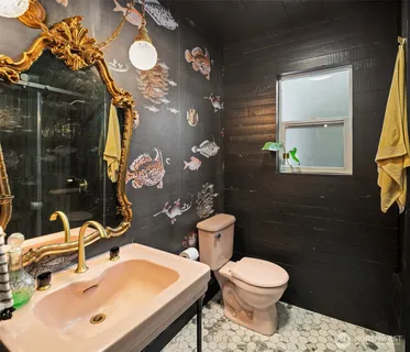 a bathroom with a toilet sink and mirror