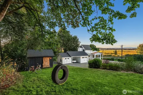 a backyard of a house with table and chairs