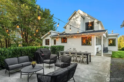 a backyard of a house with outdoor seating