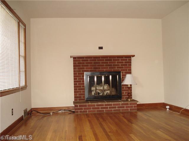 110 Oak Summit Road Winston-Salem, NC 27105 - Photo 6 of 16 Living Room. Nice hardwood floors featured in Living Room with masonry fireplace