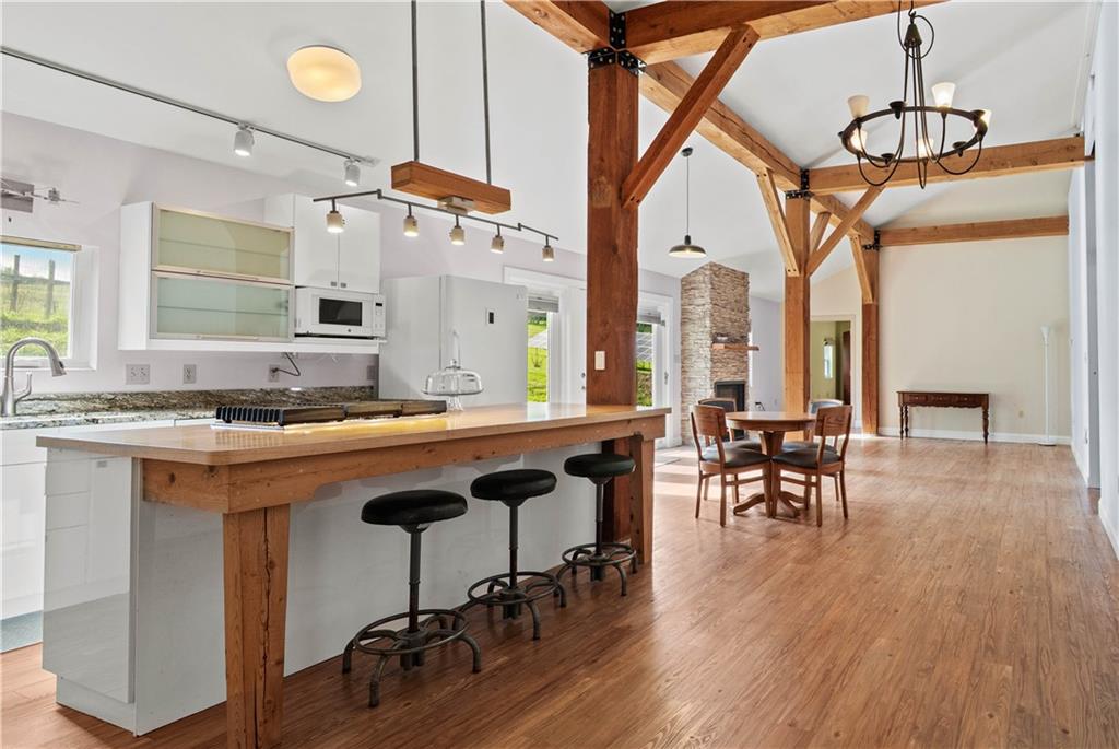 596 Wulfert Road Rochester Mills, PA 15771 - Photo 31 of 49 a open kitchen with a table chairs and wooden floors