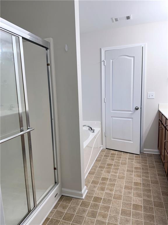 82 Kennedy Court Hiram, GA 30141 - Photo 21 of 26 a bathroom with a glass door shower and a sink