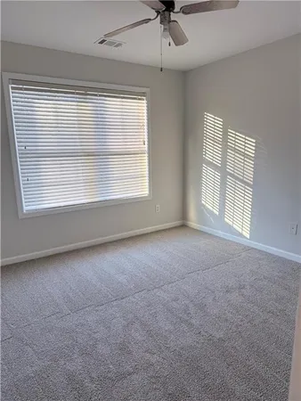 a bathroom with a sink a toilet and a window