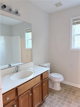 an empty room with cabinet and mirror