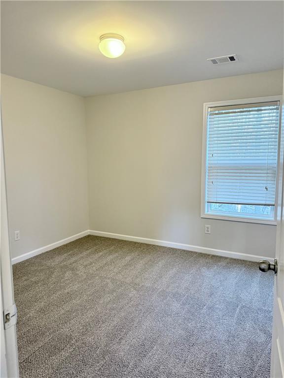 82 Kennedy Court Hiram, GA 30141 - Photo 26 of 26 an empty room with cabinet and mirror