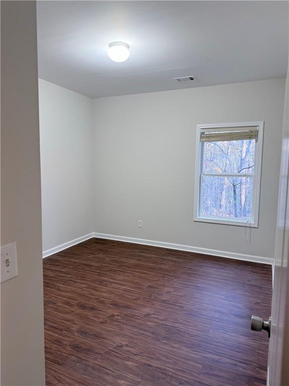 82 Kennedy Court Hiram, GA 30141 - Photo 8 of 26 an empty room with wooden floor and windows