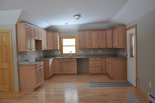 204 Fitchburg Road Townsend, MA 01469 - Photo 17 of 29 a kitchen with stainless steel appliances granite countertop a stove a sink and a refrigerator