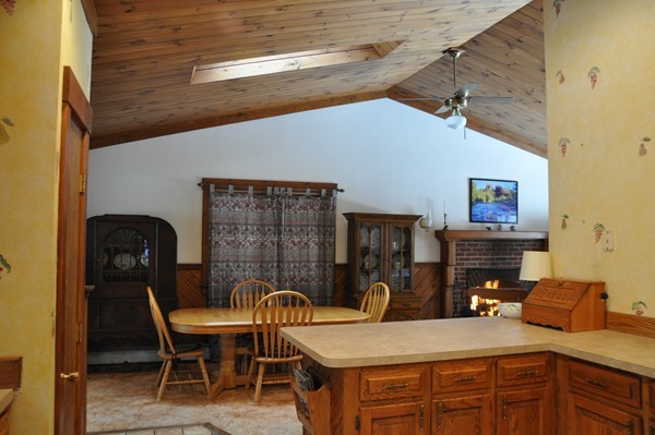 204 Fitchburg Road Townsend, MA 01469 - Photo 3 of 29 a kitchen with a table chairs and a wooden floor