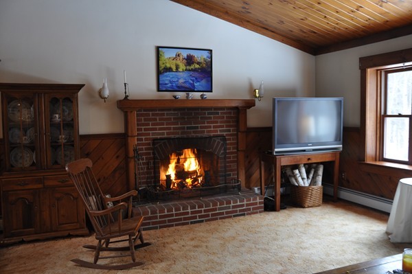 204 Fitchburg Road Townsend, MA 01469 - Photo 5 of 29 a living room with furniture a fireplace and a flat screen tv