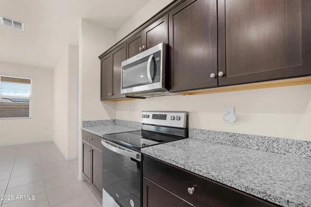 a kitchen with a sink cabinets and microwave