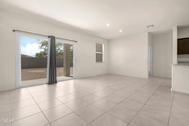 a view of an empty room and a window