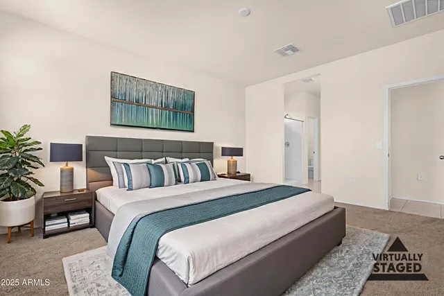 a bedroom with a bed a potted plant and a window