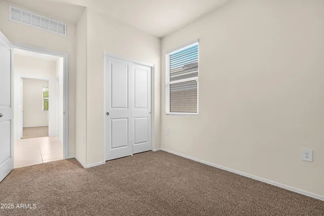 a view of a house with a yard and wooden fence