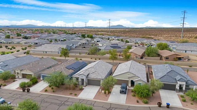 an aerial view of residential houses with outdoor space and ocean view