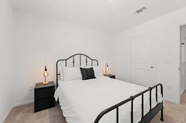 a bedroom with a bed and a table