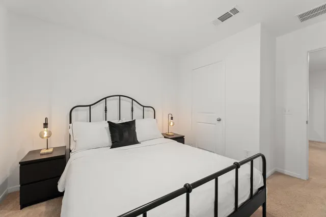 a bedroom with a bed and a dresser