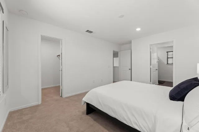 a bedroom with a bed and a closet