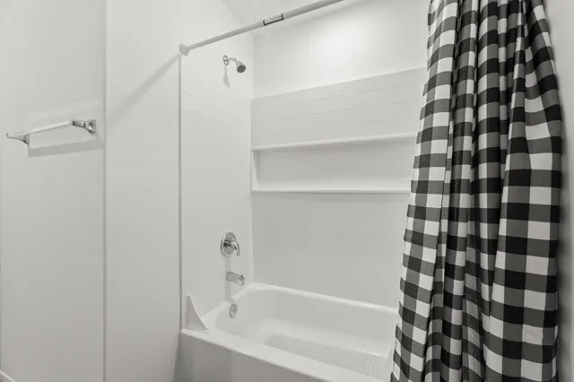 a bathroom with a bathtub and a shower