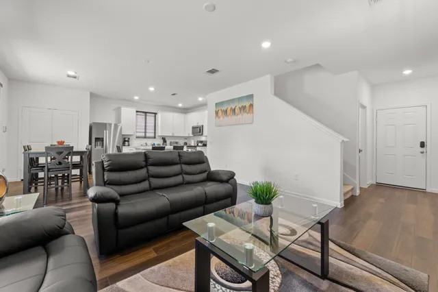 a living room with furniture and wooden floor