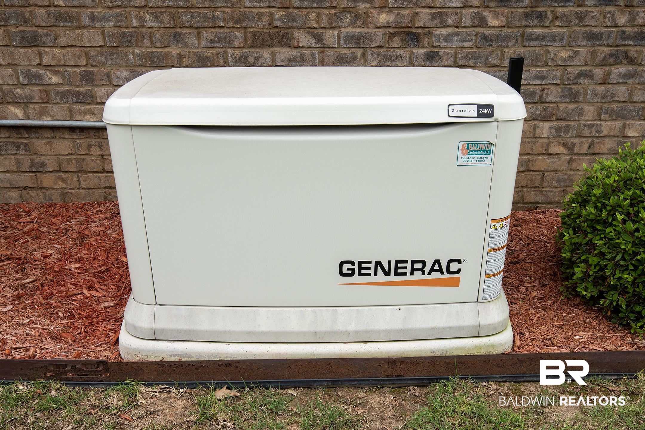 9357 Lakeview Drive Foley, AL 36535 - Photo 19 of 68 Generac Guardian Series home standby generator on a concrete pad, set against a brick exterior