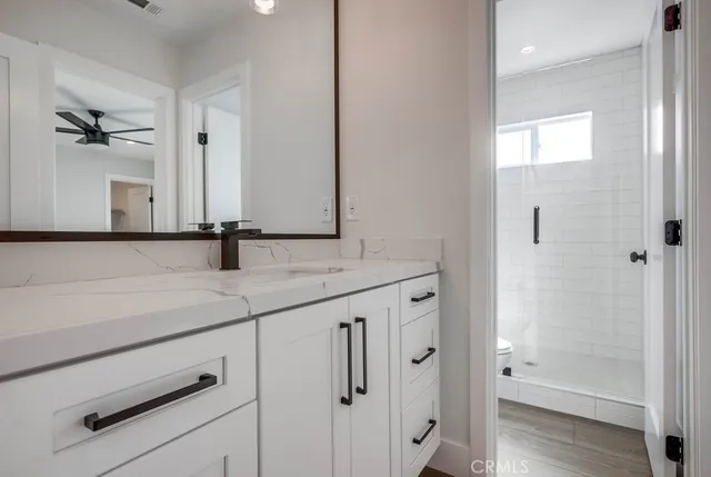a bathroom with a shower sink and mirror