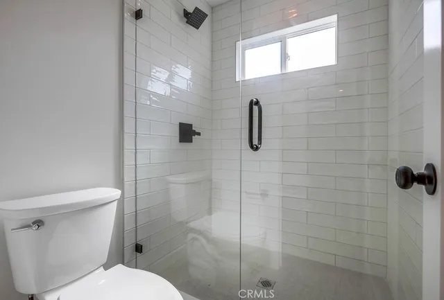 a white toilet next to a bathroom sink