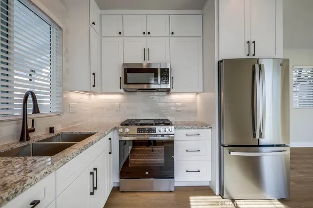 a kitchen with a refrigerator stove and sink