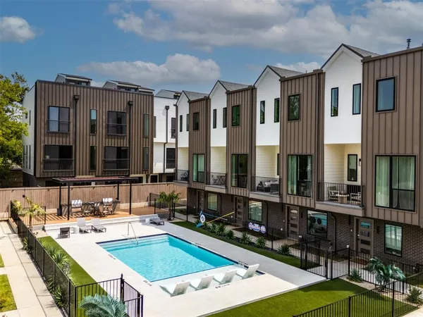 a view of a house with pool and chairs